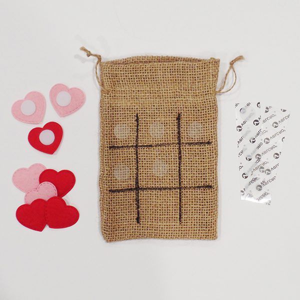 Burlap bag with tic-tac-toe grid and heart-shaped pieces with VELCRO(R) Brand Thin Dots