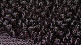 Close up of black woven loop from a VELCRO® Brand hook and loop fastener.