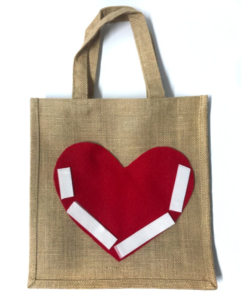 Hessian bag with red felt heart that has VELCRO(R) Brand Sticky Back for Fabrics.