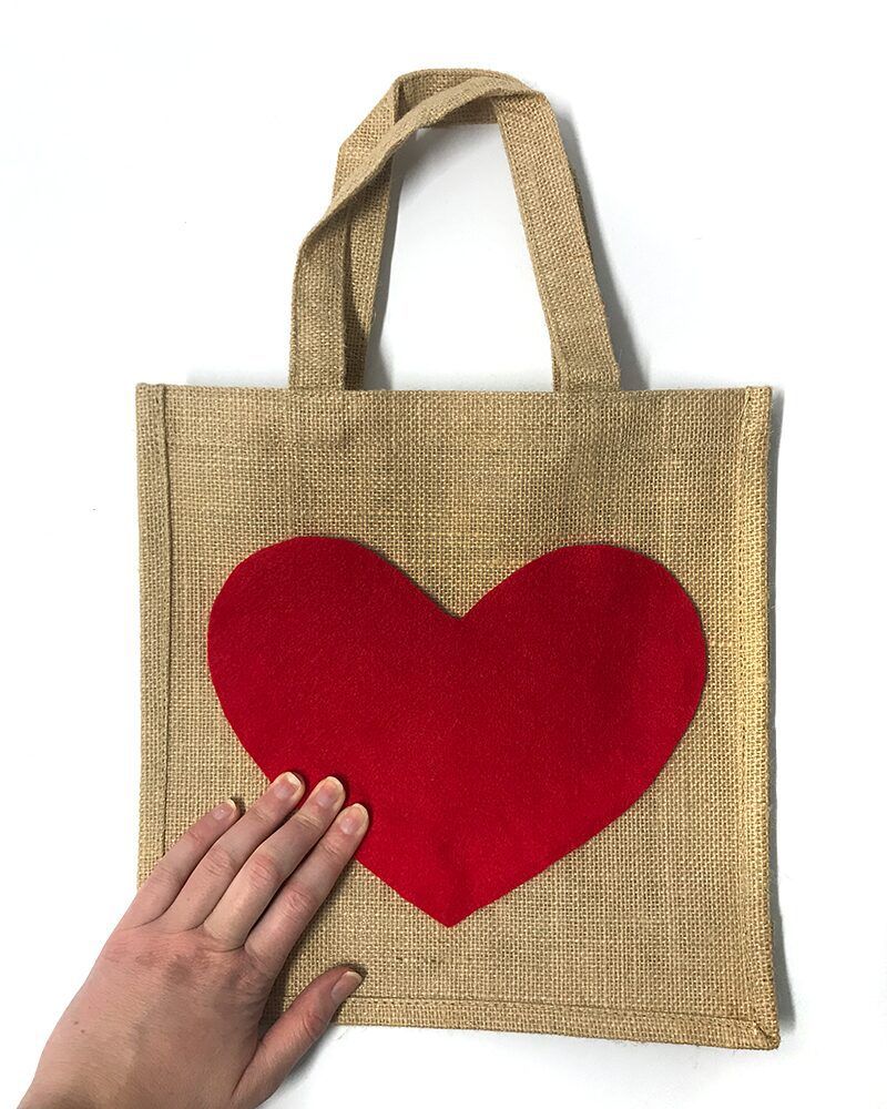 DIY Valentine's Day gift bag made with a hessian bag and a red felt heart.