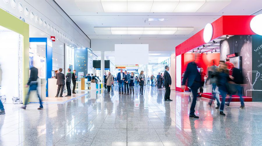 People walking past professional trade show displays