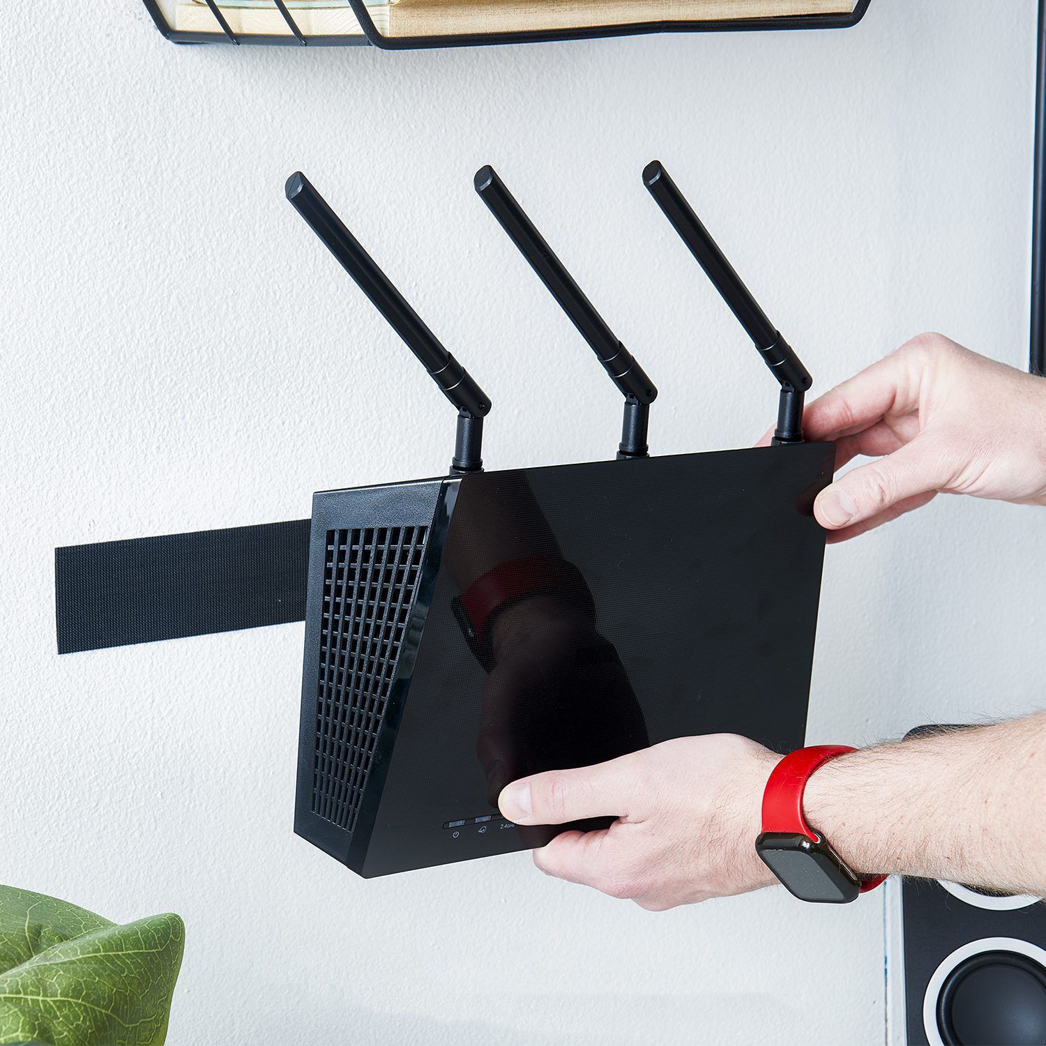 VELCRO® Brand ECO Collection Industrial Tape mounting wifi router to wall.